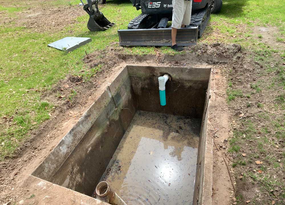 Cleaning septic tank area during septic tank maintenance in Hinesville, GA